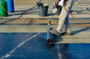 a commercial roofer in austin texas installing a new flat roof on a commercial building