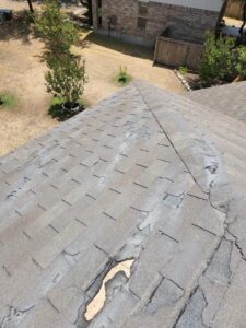 a home in austin with a damaged shingle roof