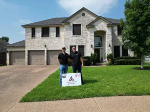 roofsonly.com staff zach and jake in front of a recently finished roofing project in austin texas