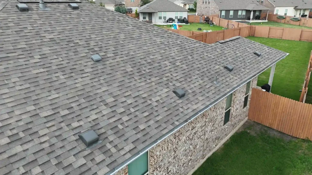 New asphalt-shingle roof on brick house