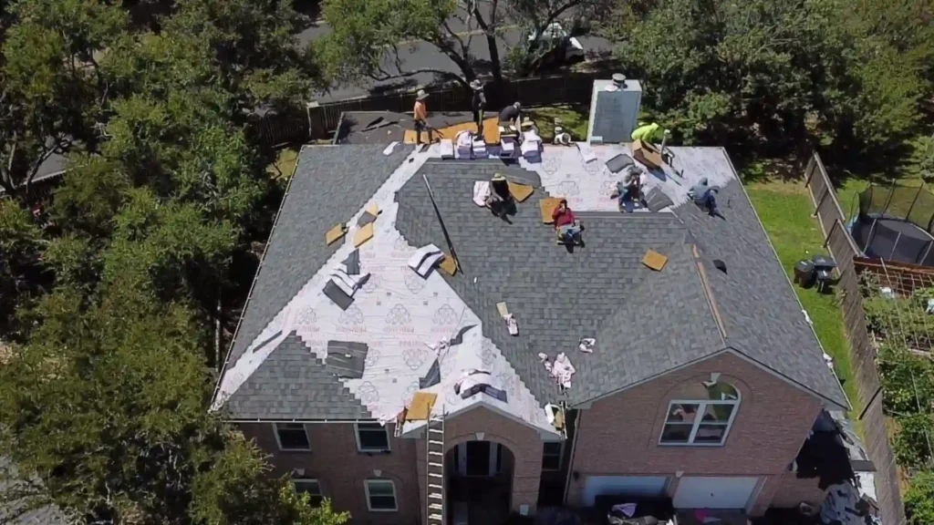 Roof being repaired with workers and materials on site