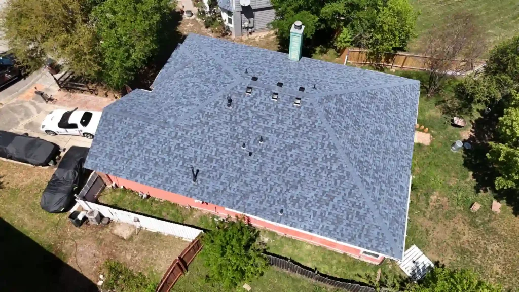 Aerial view of new gray asphalt-shingle roof after installation