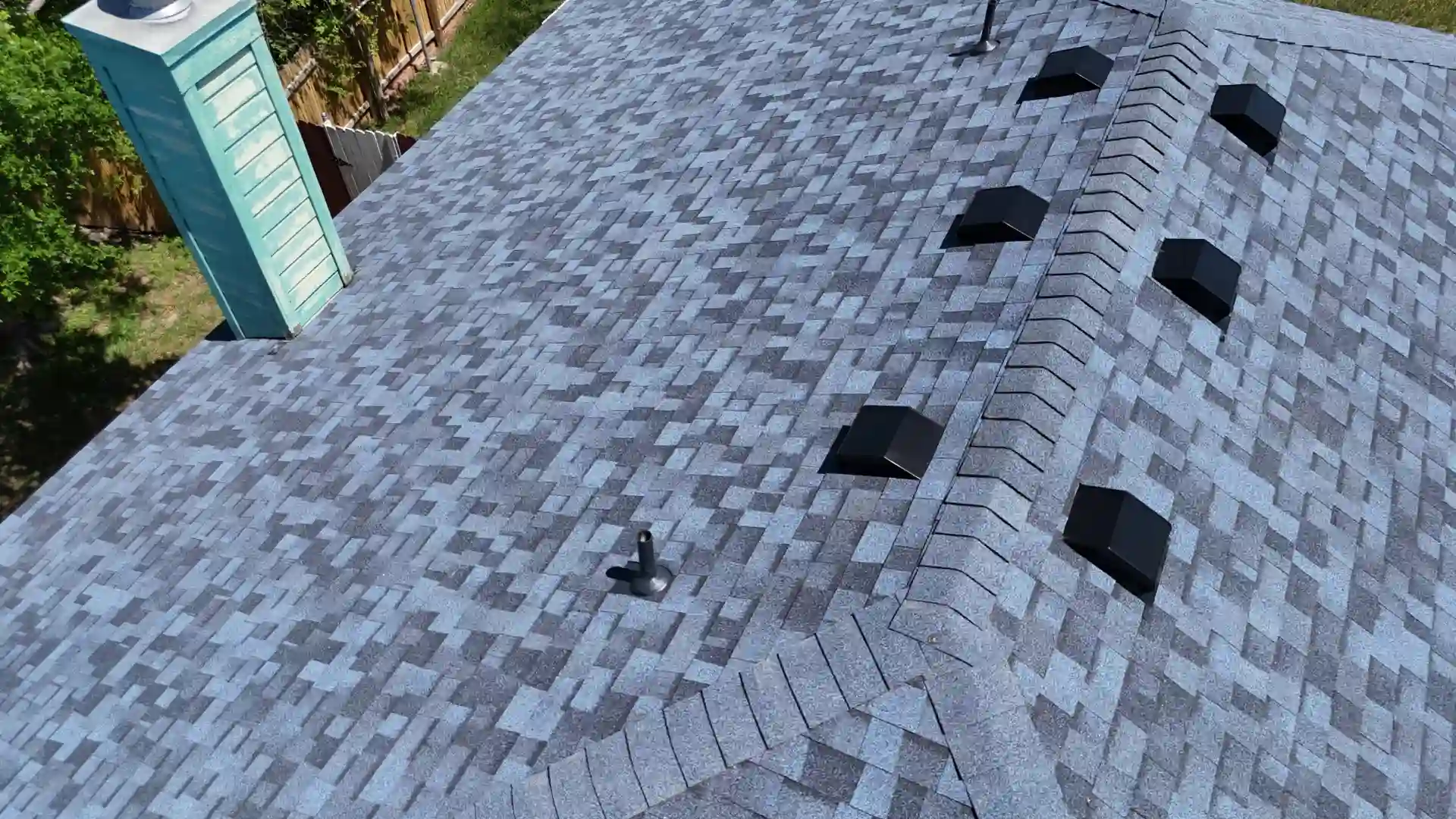 New gray asphalt-shingle roof with ridge vents