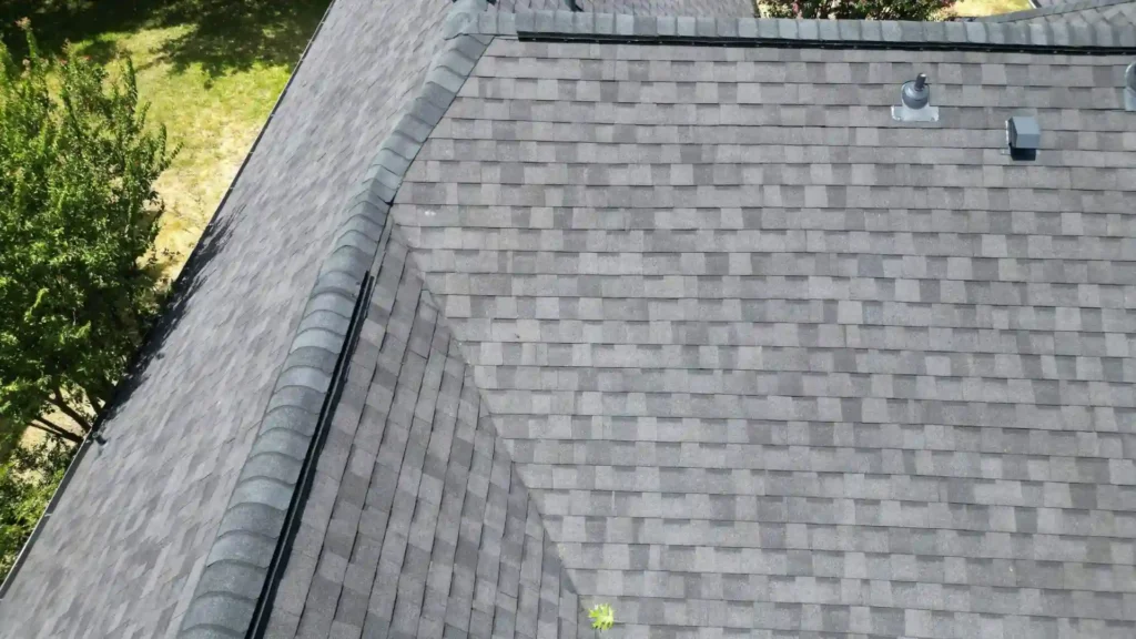 Close-up of gray shingle roof with ridge cap detail