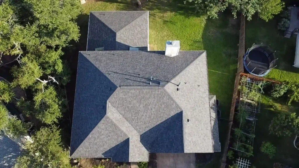 Aerial view of a dark-gray shingle roof with multiple ridges and vents