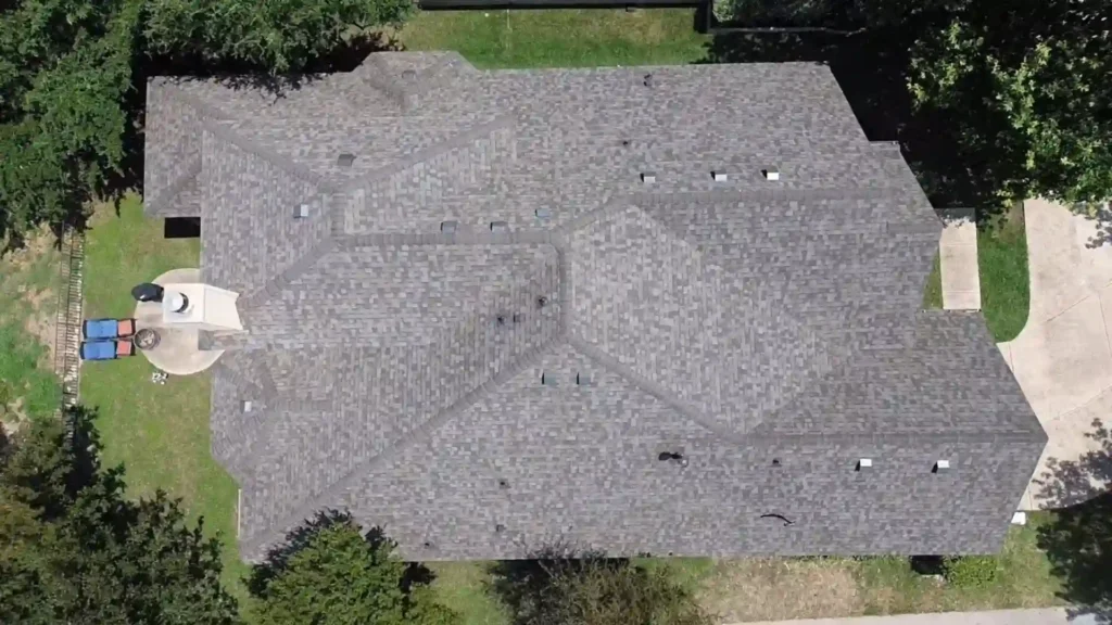 Aerial view of a large roof with gray asphalt shingles.