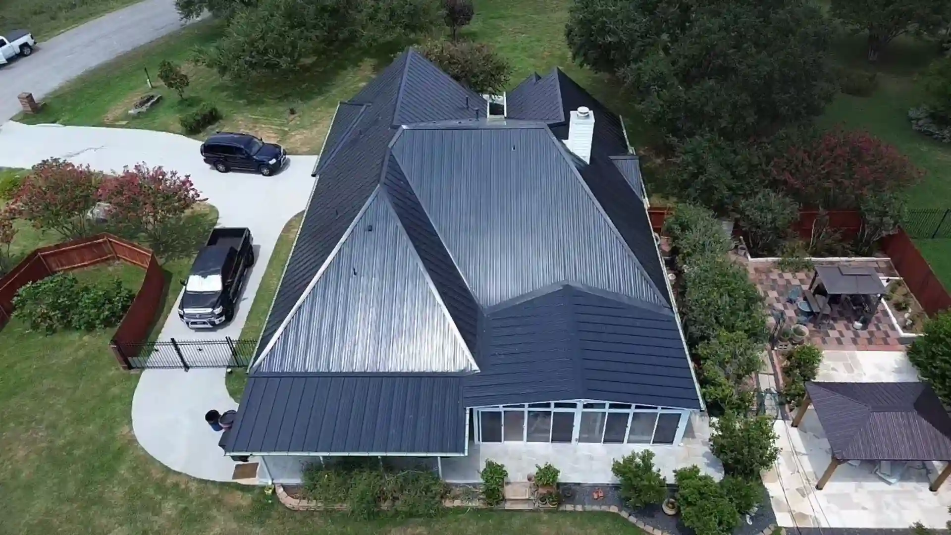 Aerial view of a house with a dark metal roof