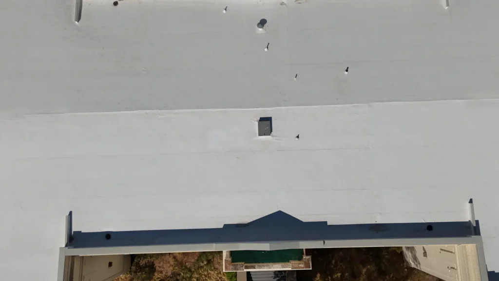 Close-up aerial view of flat white commercial roof