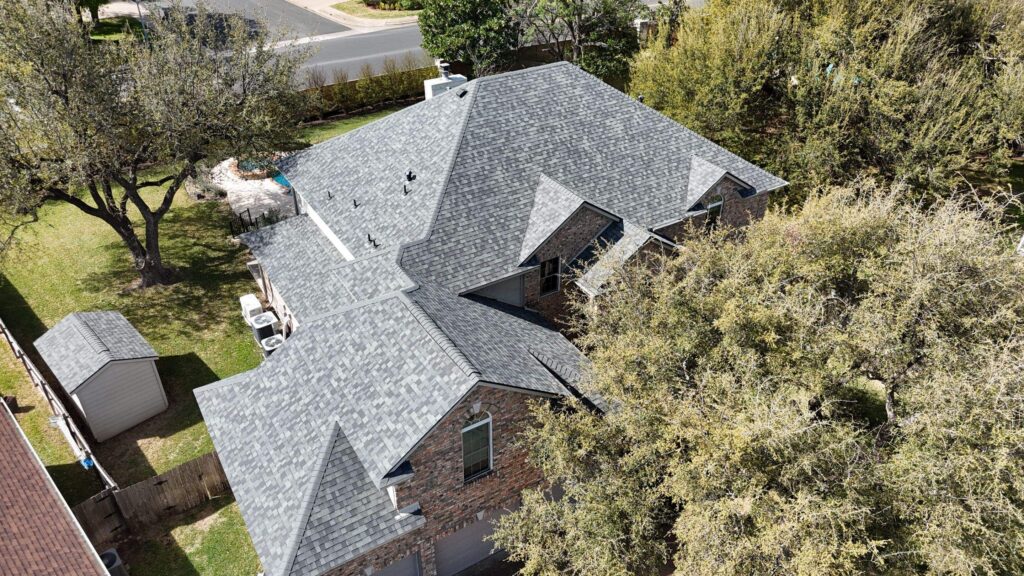 Architectural asphalt shingle roof replacement on a limestone home in Brushy Creek near Cedar Park