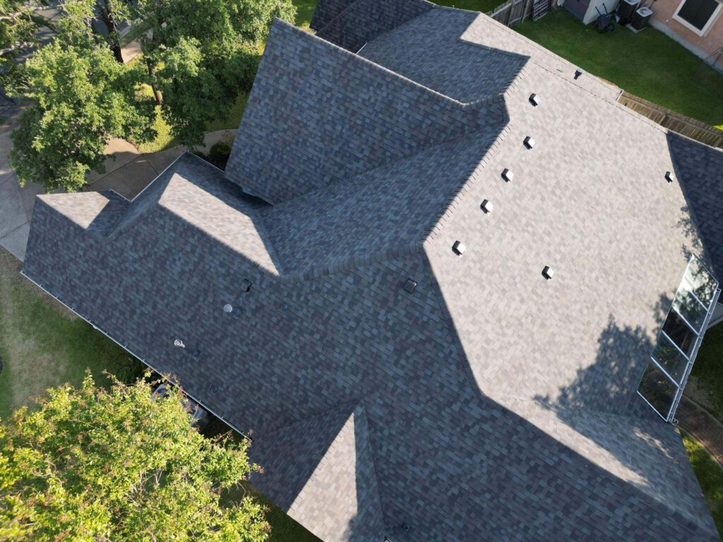 Asphalt shingle roof replacement on a Brushy Creek home with multiple gables and a sunroom