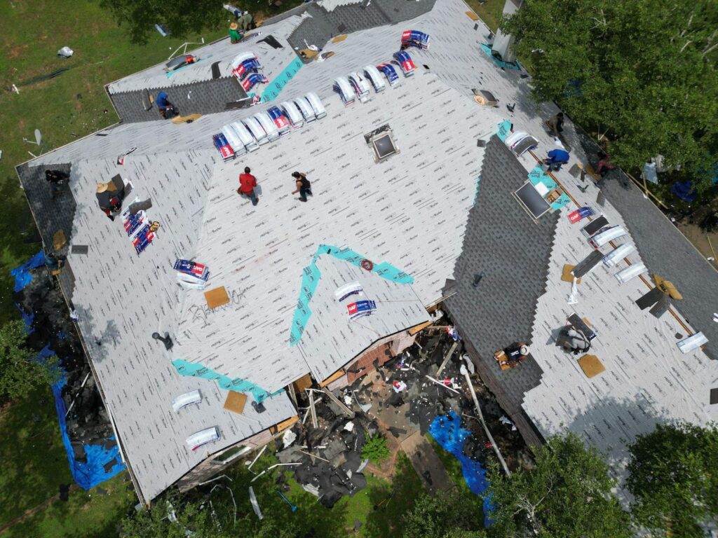 RoofsOnly crew installing synthetic underlayment and GAF shingles on a Shady Hollow roof replacement
