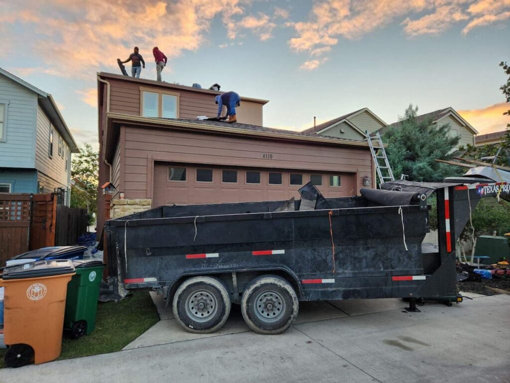 New architectural asphalt shingles being installed on a 2000 square foot Austin Texas home