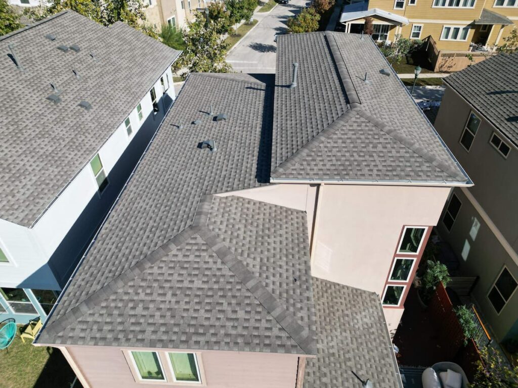 Roofing contractor measuring roof squares on a residential home in Austin Texas