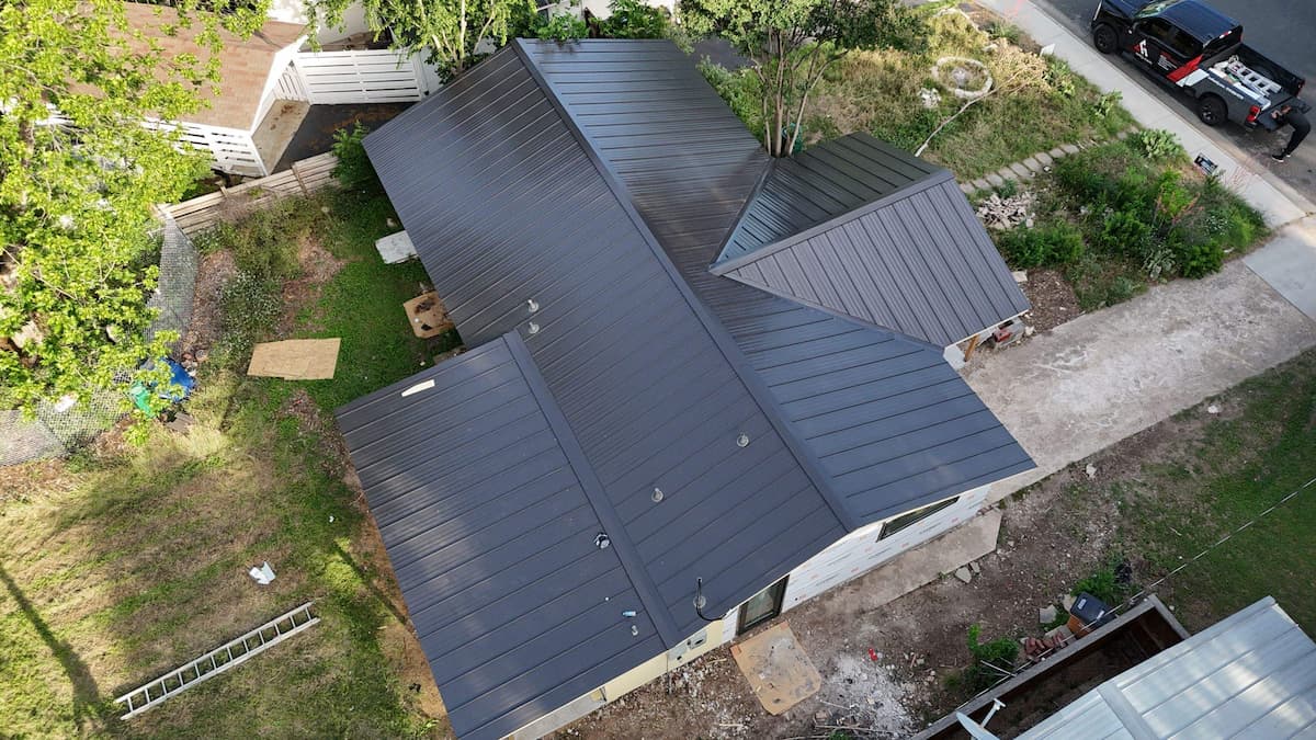 Close-up of standing seam metal roof panels showing concealed fastener seam profile