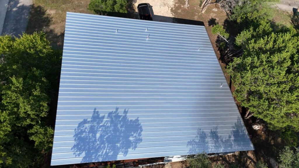 Standing seam metal roof installed on a residential home in Austin Texas reflecting heat in summer sun2