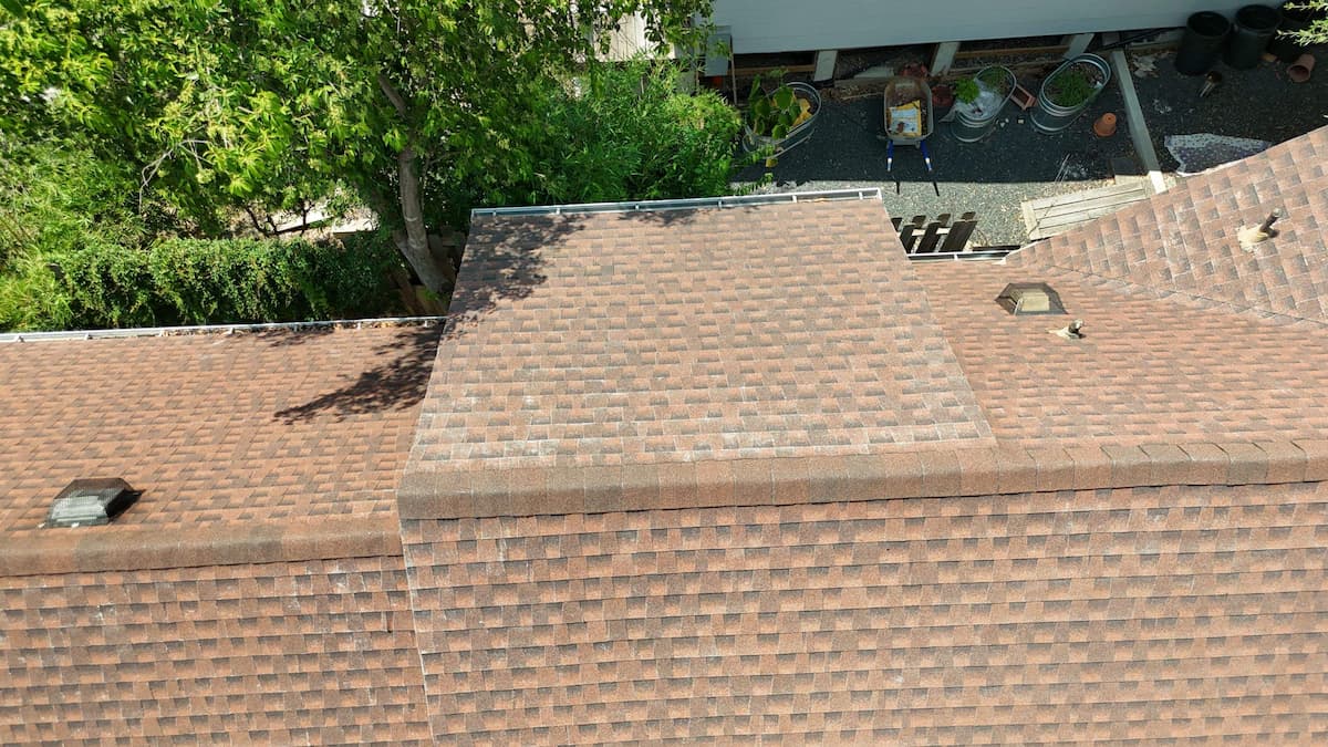 RoofsOnly.com contractor inspecting a steep pitched roof on an older Central Austin home in a historic neighborhood