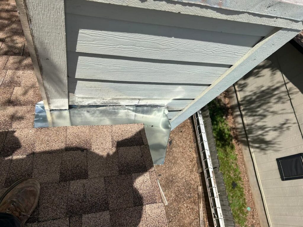 RoofsOnly.com contractor replacing flashing at a chimney on an Austin Texas residential roof