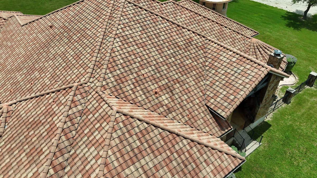 Comparison of heat-resistant roofing materials including clay tile, metal and cool roof shingles on homes in Austin Texas