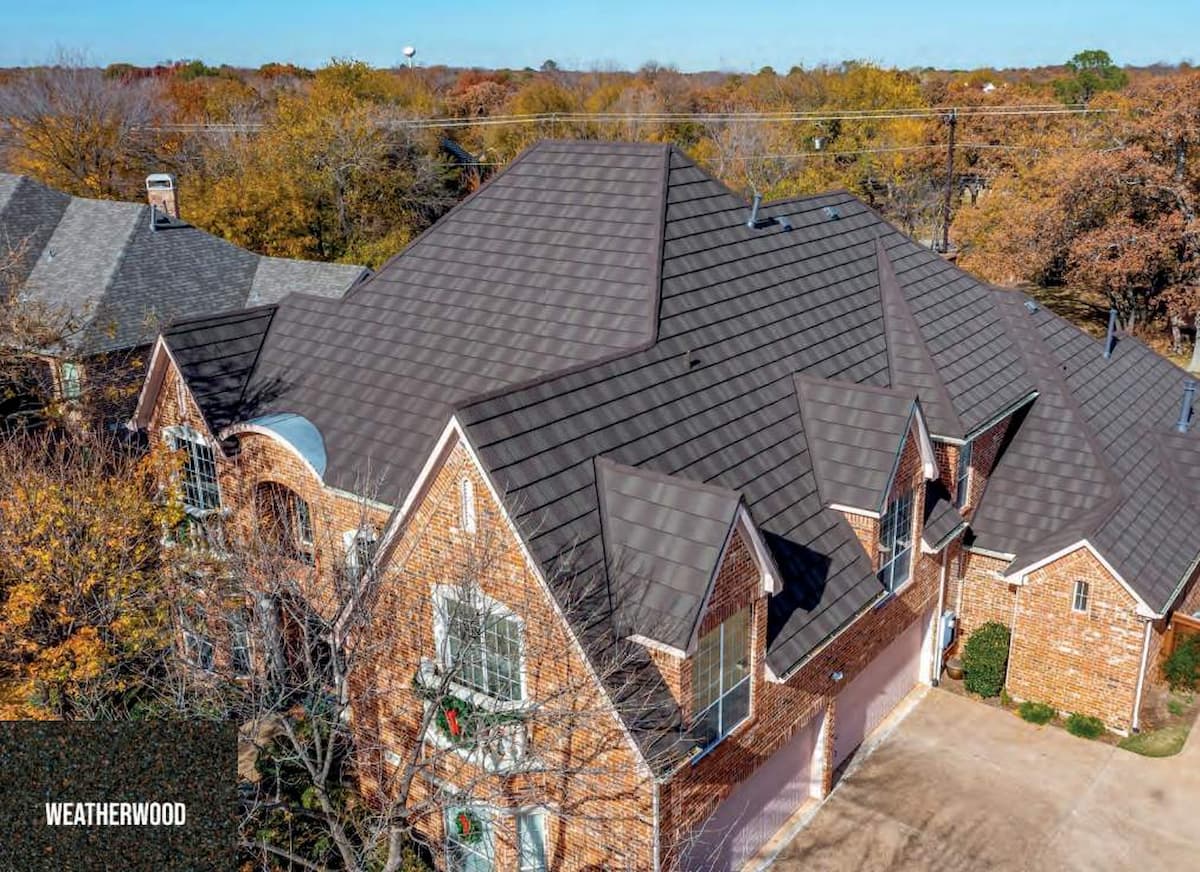 Aerial view of a residential brick house in Austin with a brown Weatherwood TEK metal shingle roof.