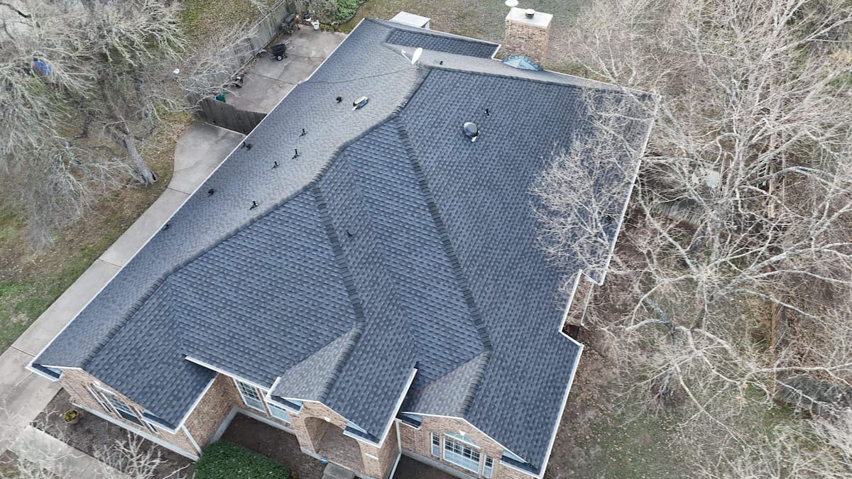 Completed architectural shingle roof on a home in Buda TX