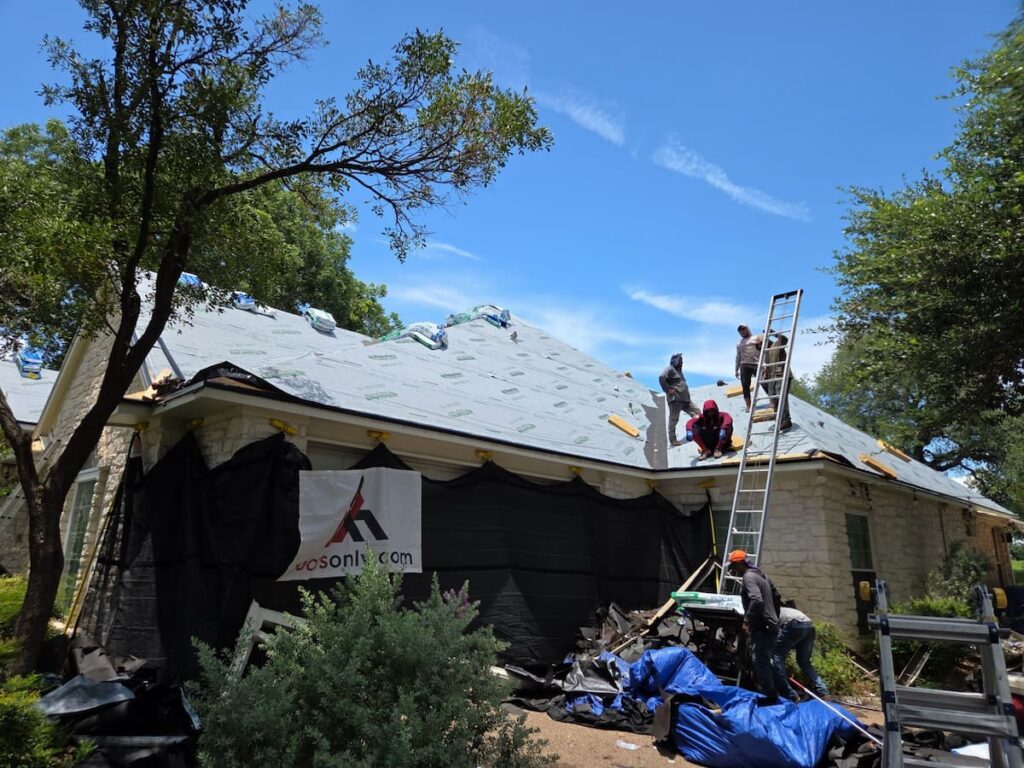 Catch-All protective netting system installed around a two-story home during a residential roof tear-off in Austin, Texas.