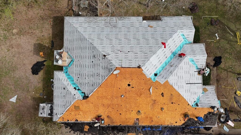 RoofsOnly.com crew installing underlayment during a roof replacement in Buda TX